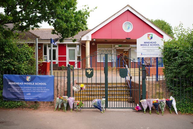 Floral tributes at the entrance to the Minehead Middle School in Somerset (Ben Birchall/PA)