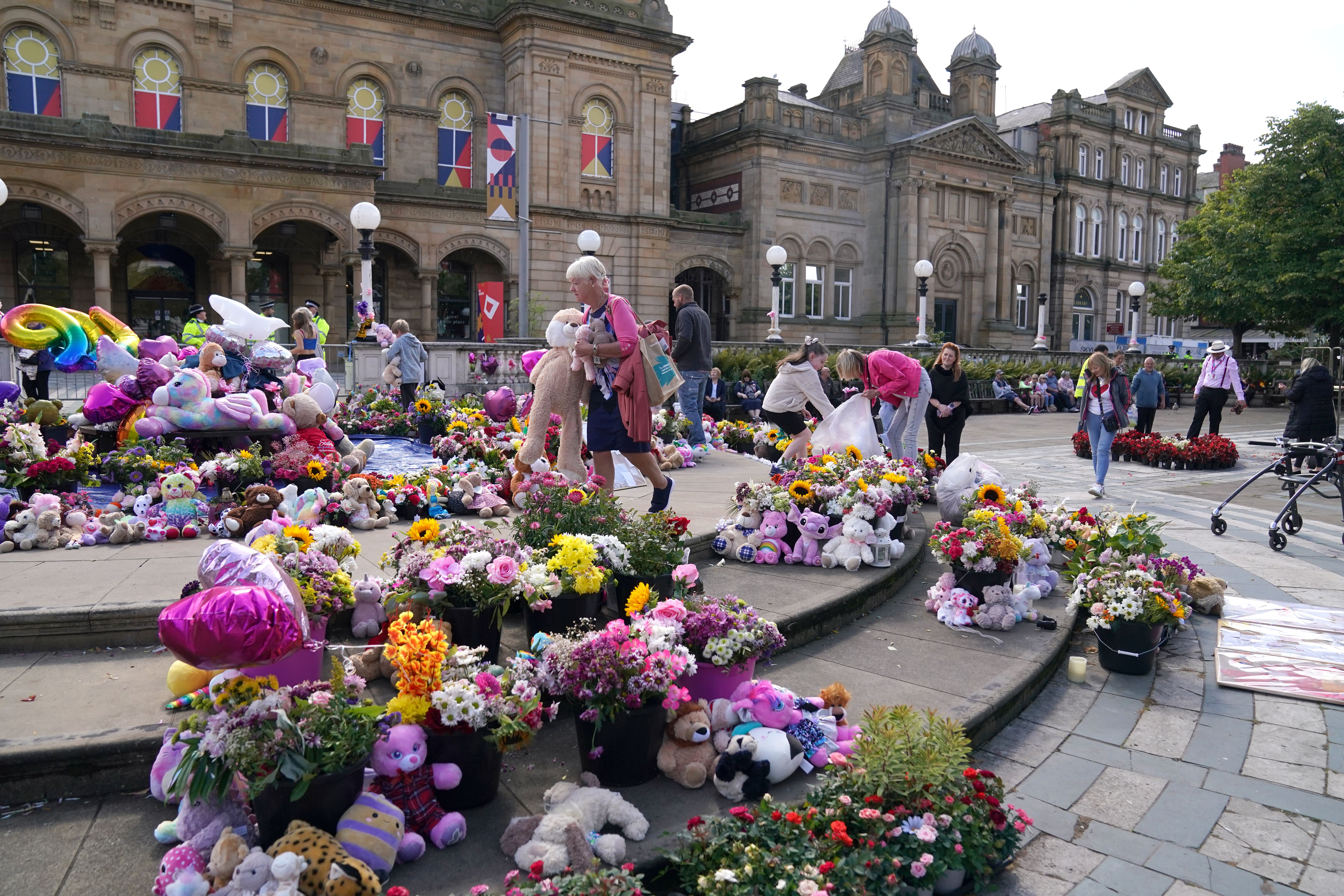 Flowers and tributes outside the Atkinson Art Centre Southport after the girls were killed in the attack (Owen Humphreys/PA)