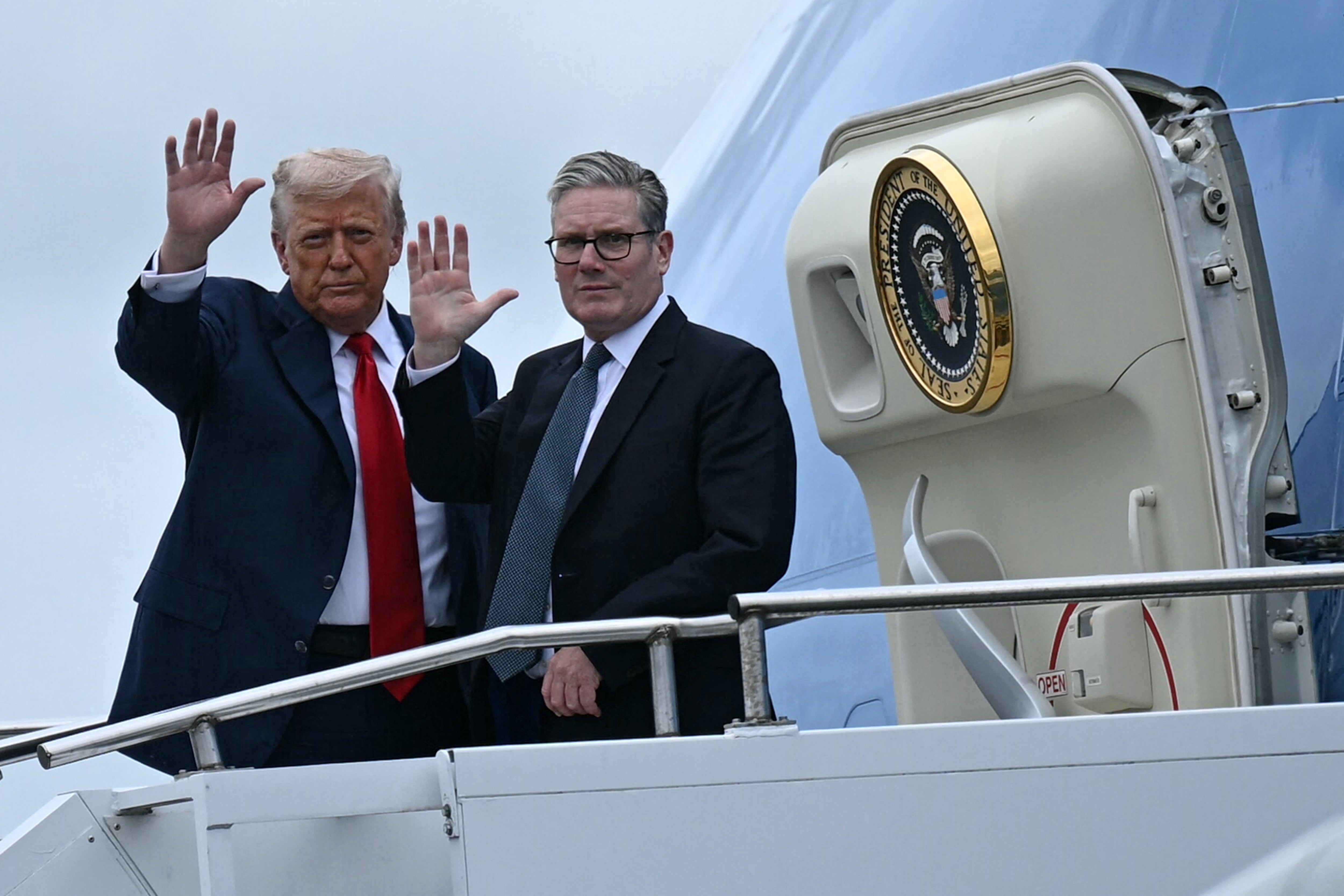Mr Trump and Sir Keir waving as they board Air Force One in Glasgow