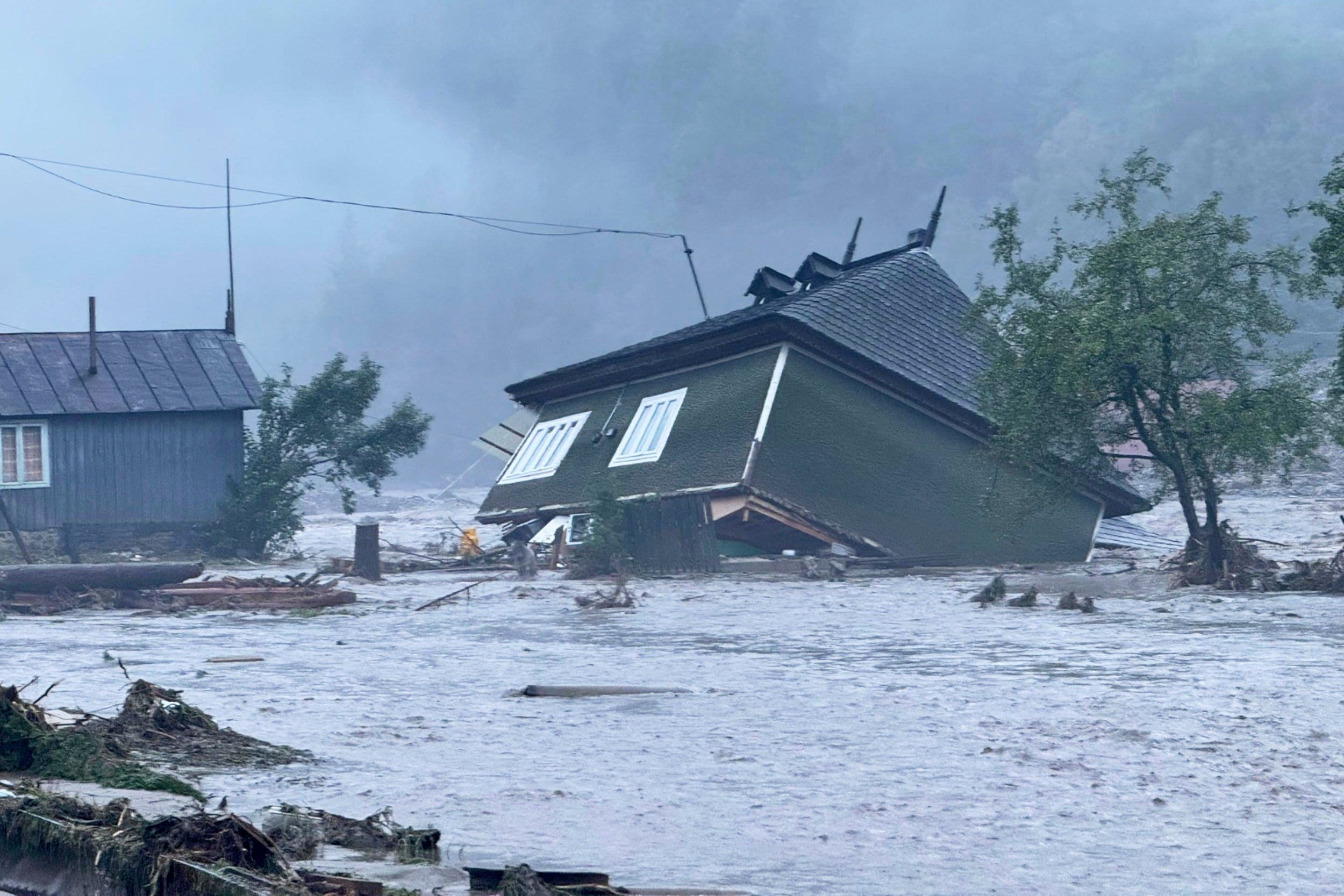 In this image released by the Romanian Emergency Services Suceava (ISU Suceava) a house is damaged after a flash flood in the village of Brosteni, northern Romania, Monday, July 28, 2025. (Romanian Emergency Services - ISU Suceava via AP)