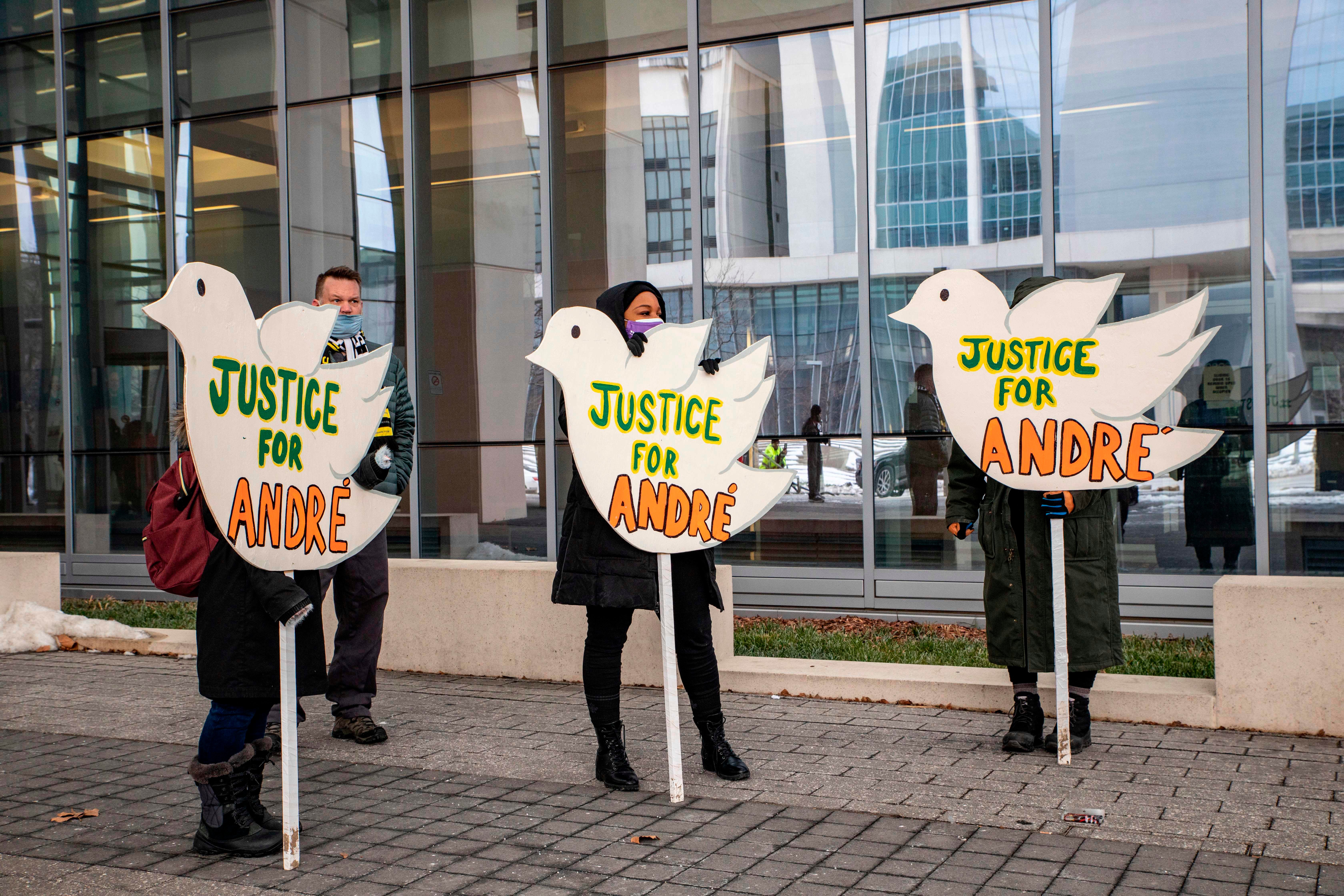 Protesters hold signs outside the Franklin County Common Pleas Courthouse after the arraignment of Coy in Columbus, Ohio, on February 5, 2021