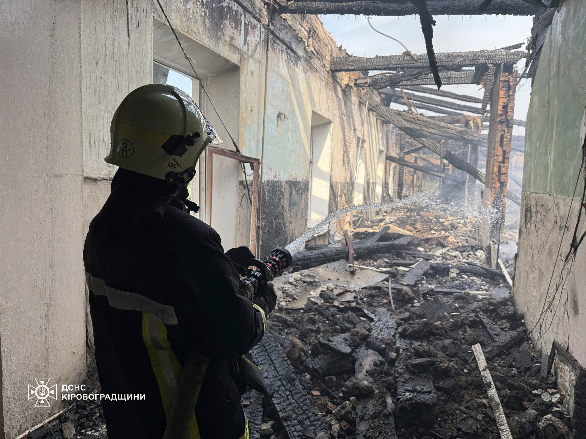 In this photo provided by the Ukrainian Emergency Service, firefighters put out the fire in a fire department school following a Russian air attack in Kropyvnytskyi, Ukraine,
