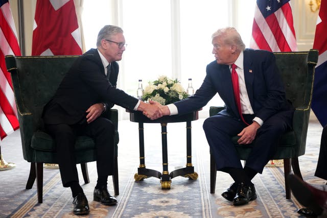 UK Prime Minister Keir Starmer and President Donald Trump shake hands while seated