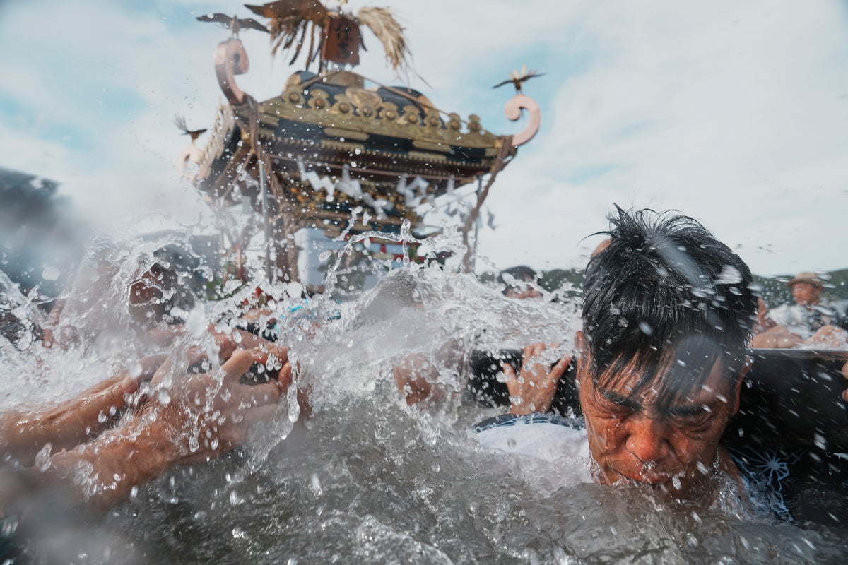 Photos show a town praying for marine safety at a seaside festival near Tokyo