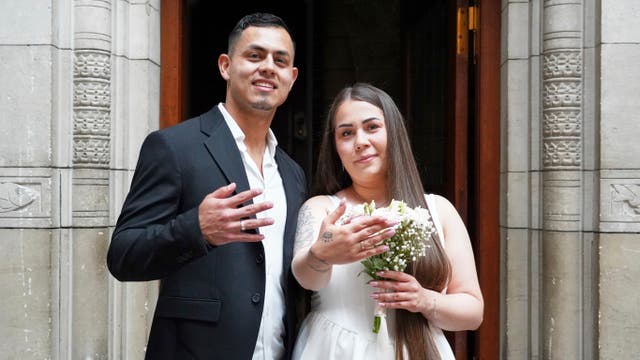<p>Newlyweds Magdalena Kujawińska, right, from Poland and Heinner Valenzuela from Colombia pose for photos at the Copenhagen City Hall in Copenhagen, Denmark</p>