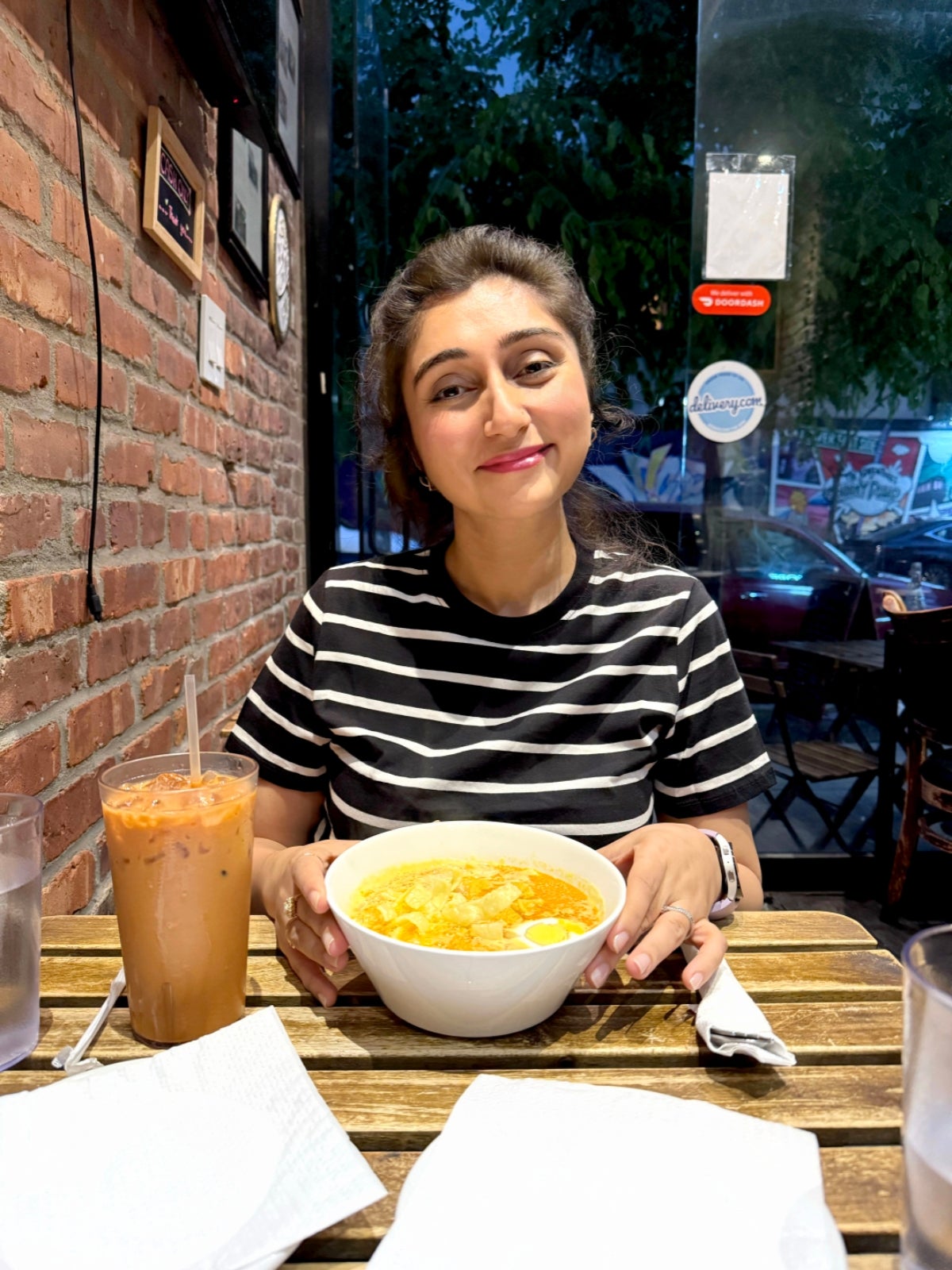 Queenie tucks into a bowl of ohn no khauk in Little Myanmar in New York's East Village