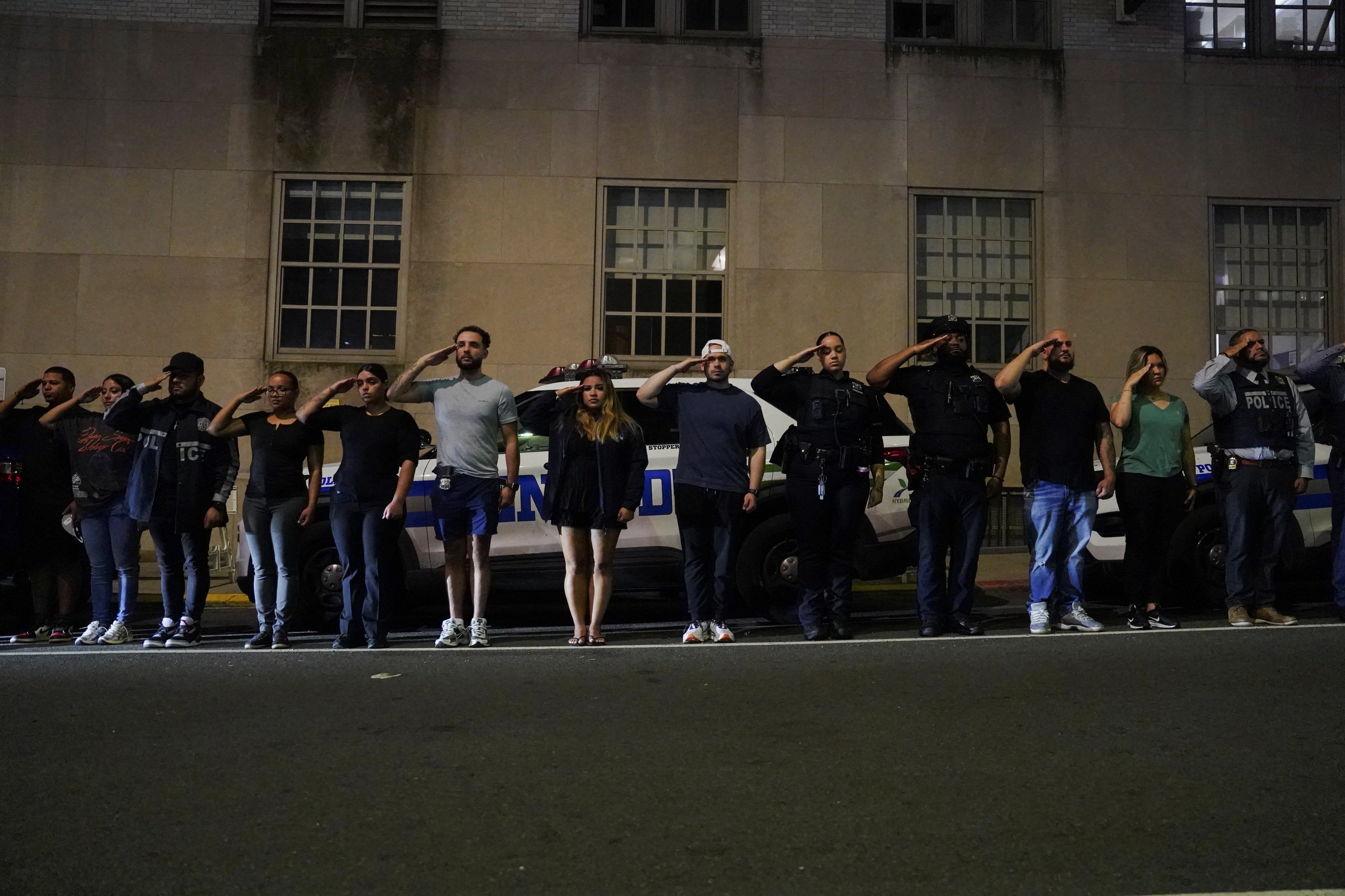 NYPD officers salute for the ambulance transfer of slain NYPD officer Didarul Islam