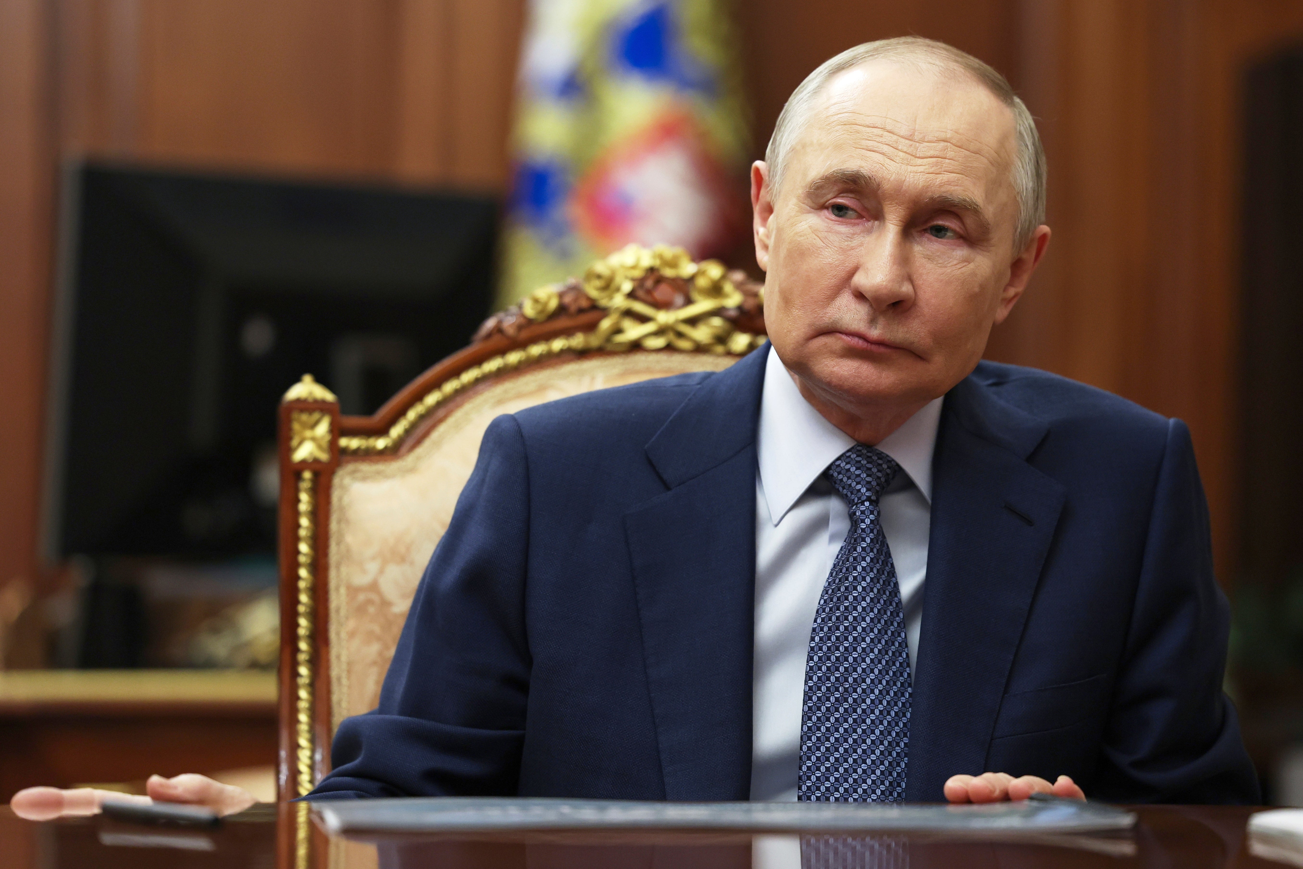 Russian president Vladimir Putin speaks with Sberbank CEO German Gref during their meeting at the Kremlin in Moscow