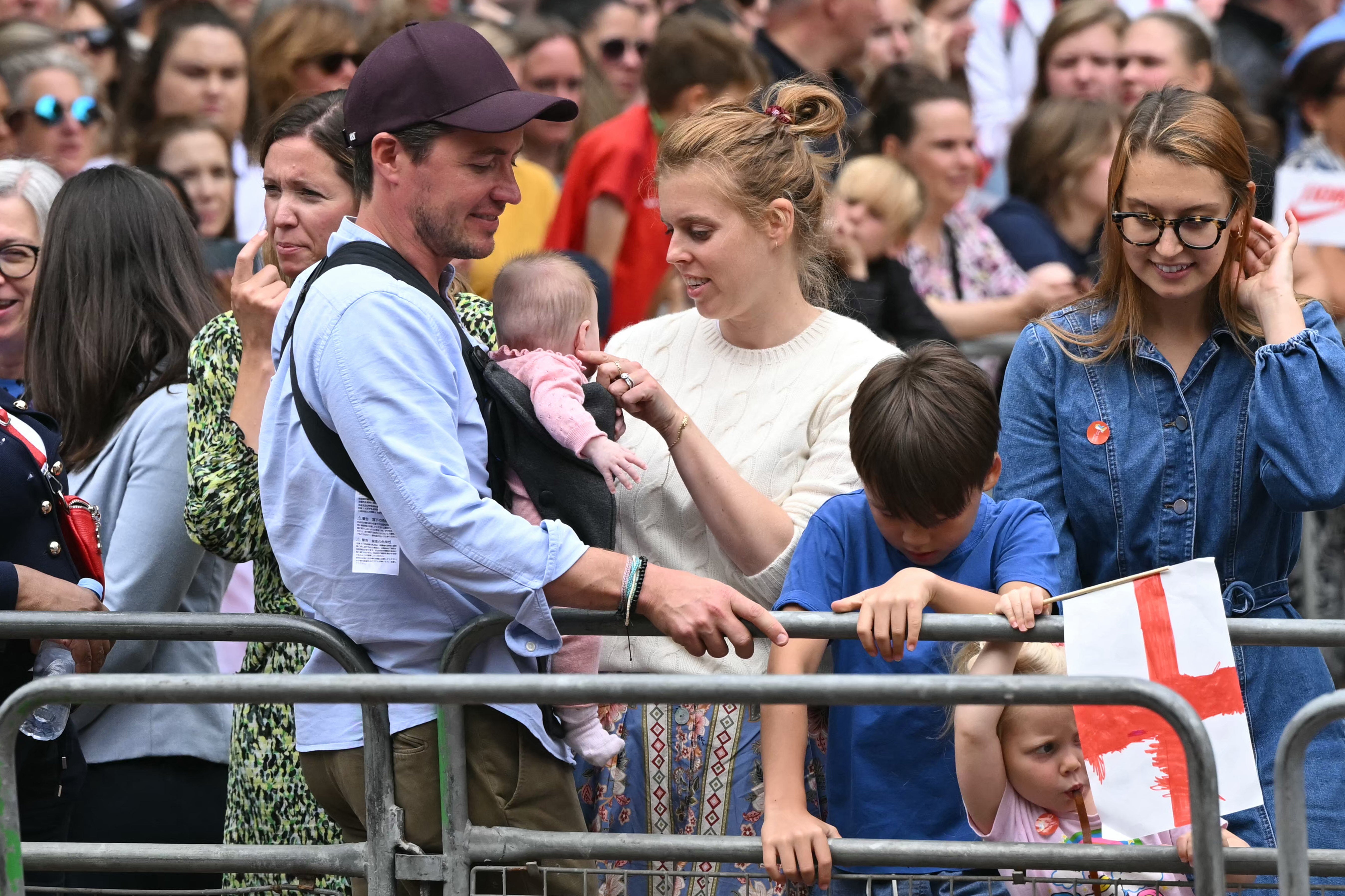 Princess Beatrice of York (C) her husband Edoardo Mozzi (CL) and children Sienna, Athena and Christopher join fans