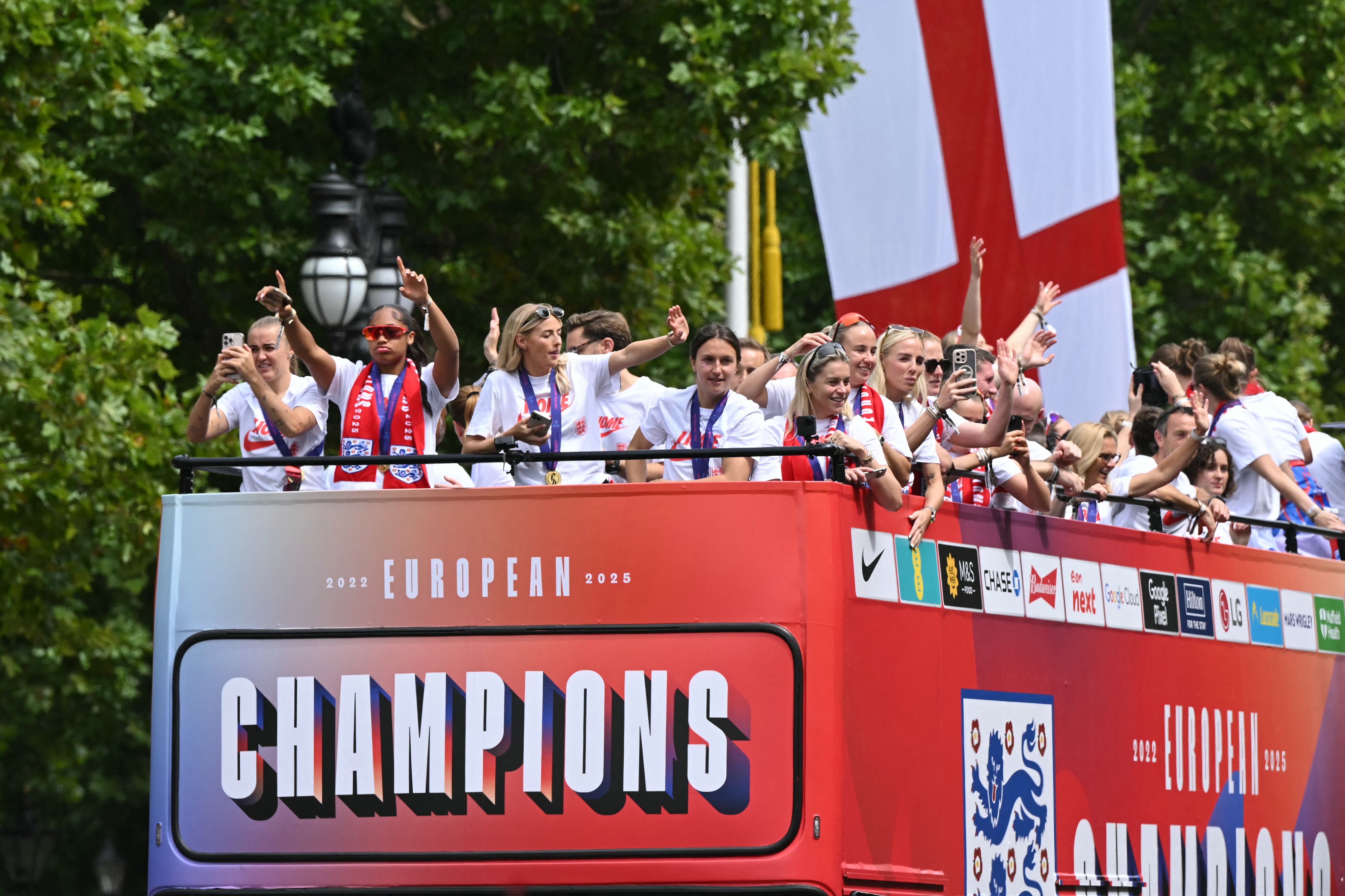 <p>The bus carrying the England women's national football team drives along the Mall during the homecoming victory parade near Buckingham Palace </p>