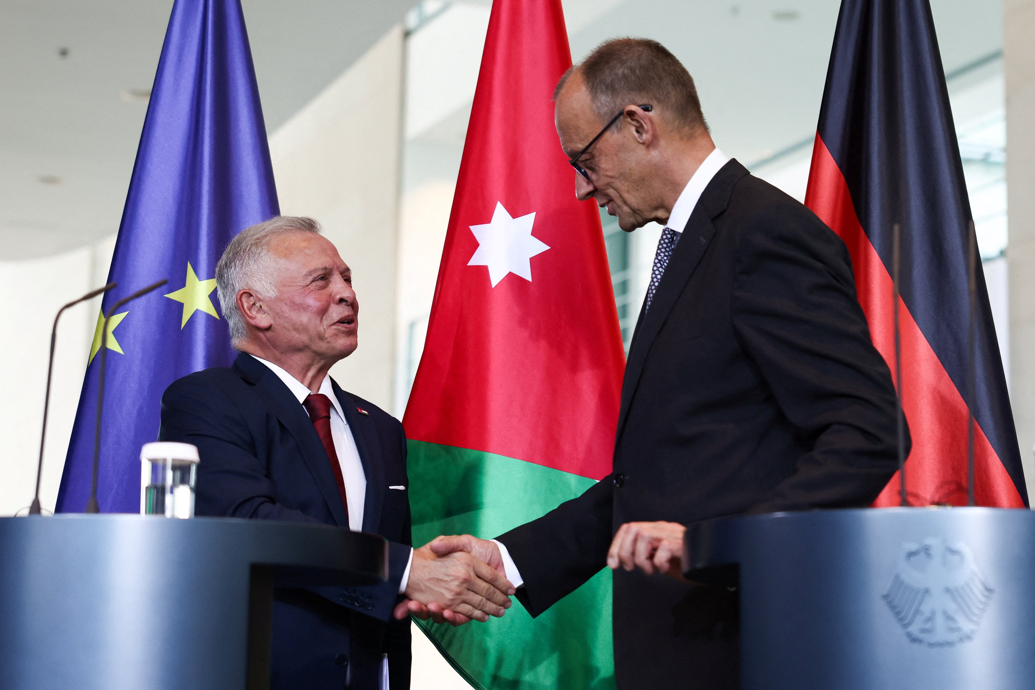 German Chancellor Friedrich Merz and Jordan's King Abdullah shake hands in Berlin