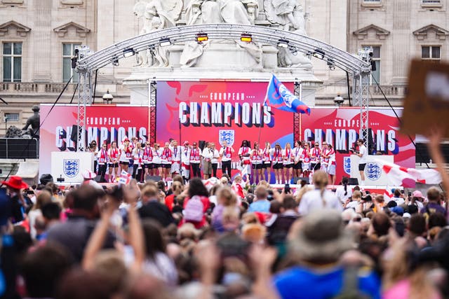 <p>The Lionesses celebrated on stage in front of Buckingham Palace after an open-top bus parade (James Manning/PA)</p>