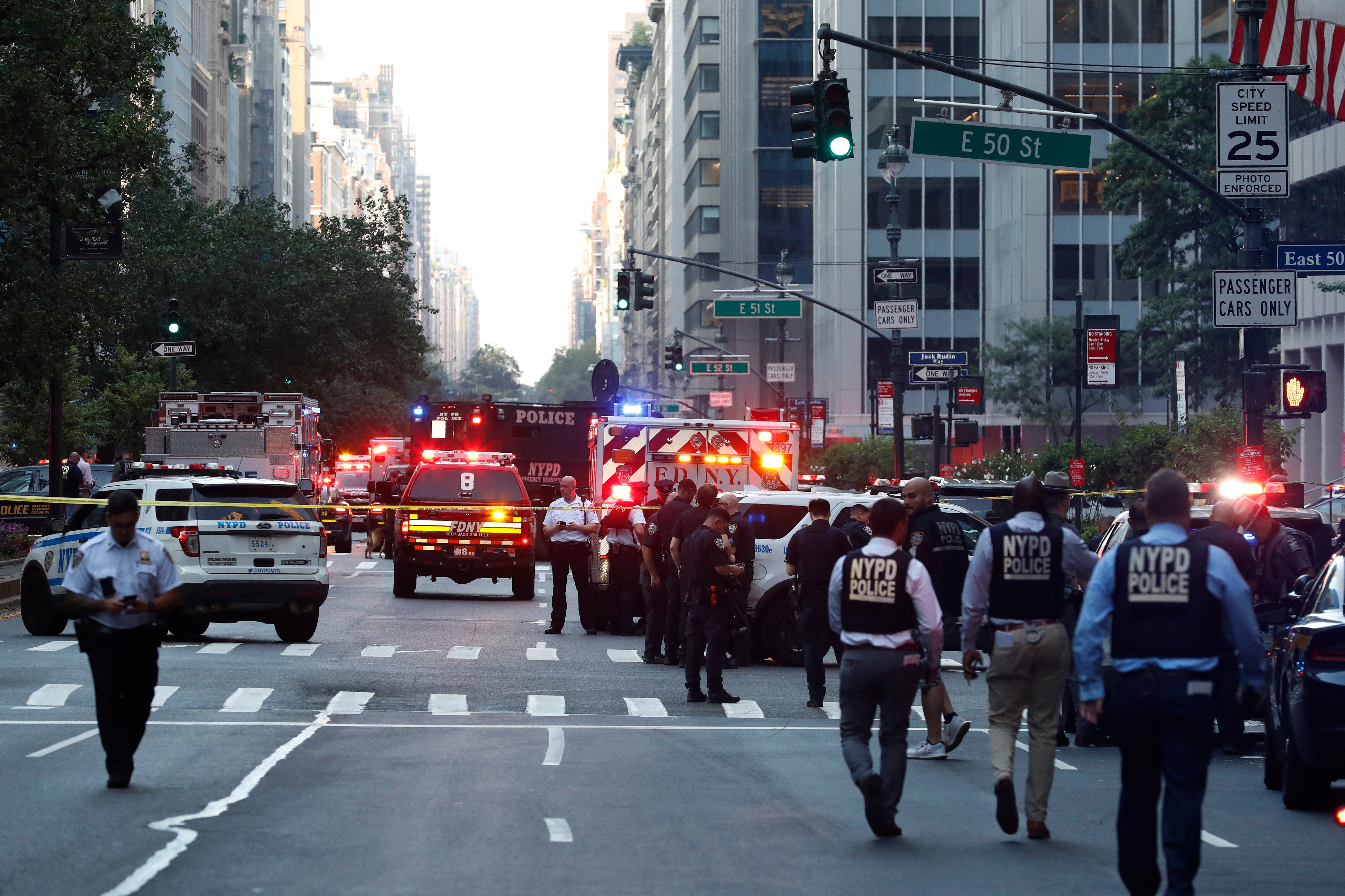 Police and emergency vehicles surround the Midtown Manhattan skyscraper after a gunman entered and started ‘spraying’ ammunition inside, killing four victims before turning the gun on himself