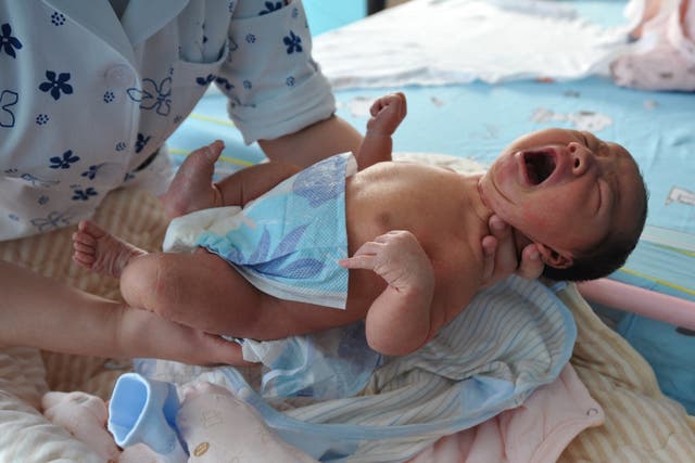 <p>A nurse takes care of a newborn baby at a hospital in Fuyang, in China's eastern Anhui province</p>