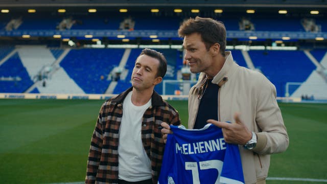 <p>Tom Brady (right), the minority owner of Birmingham City, poses alongside Wrexham owner Rob McElhenney</p>