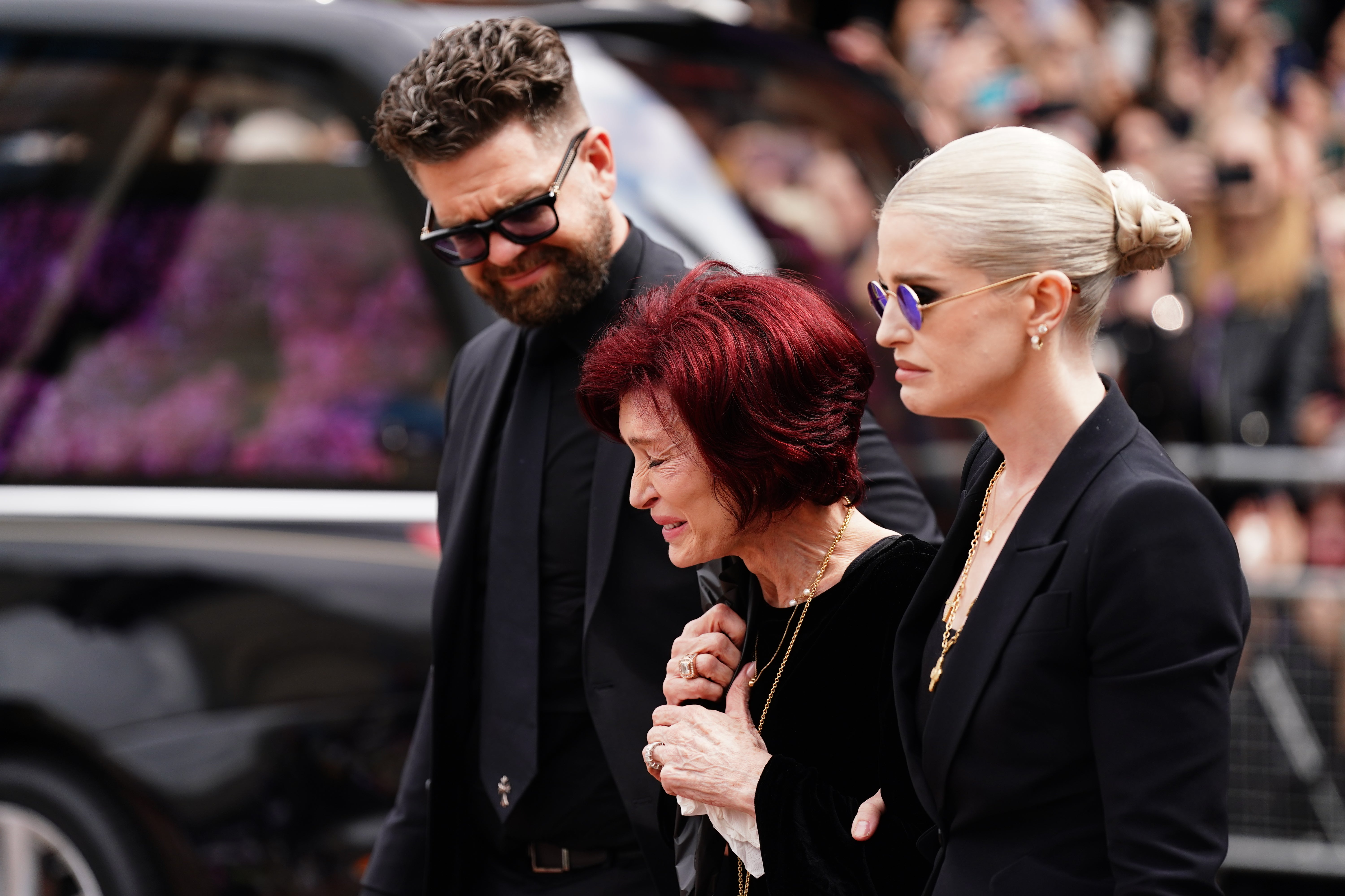 The family of Ozzy Osbourne (left to right) Jack Osbourne, Sharon Osbourne and Kelly Osbourne lay flowers