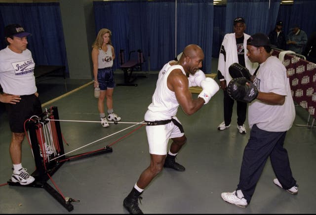 <p>Tommy Brooks (right) training Evander Holyfield in 1998</p>
