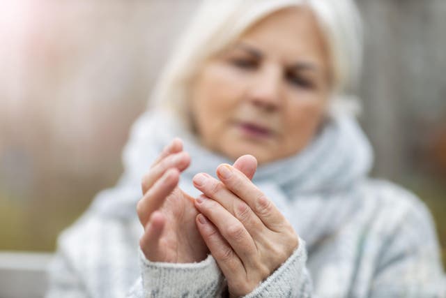 <p>A woman experiencing arthritis symptoms in her hands</p>