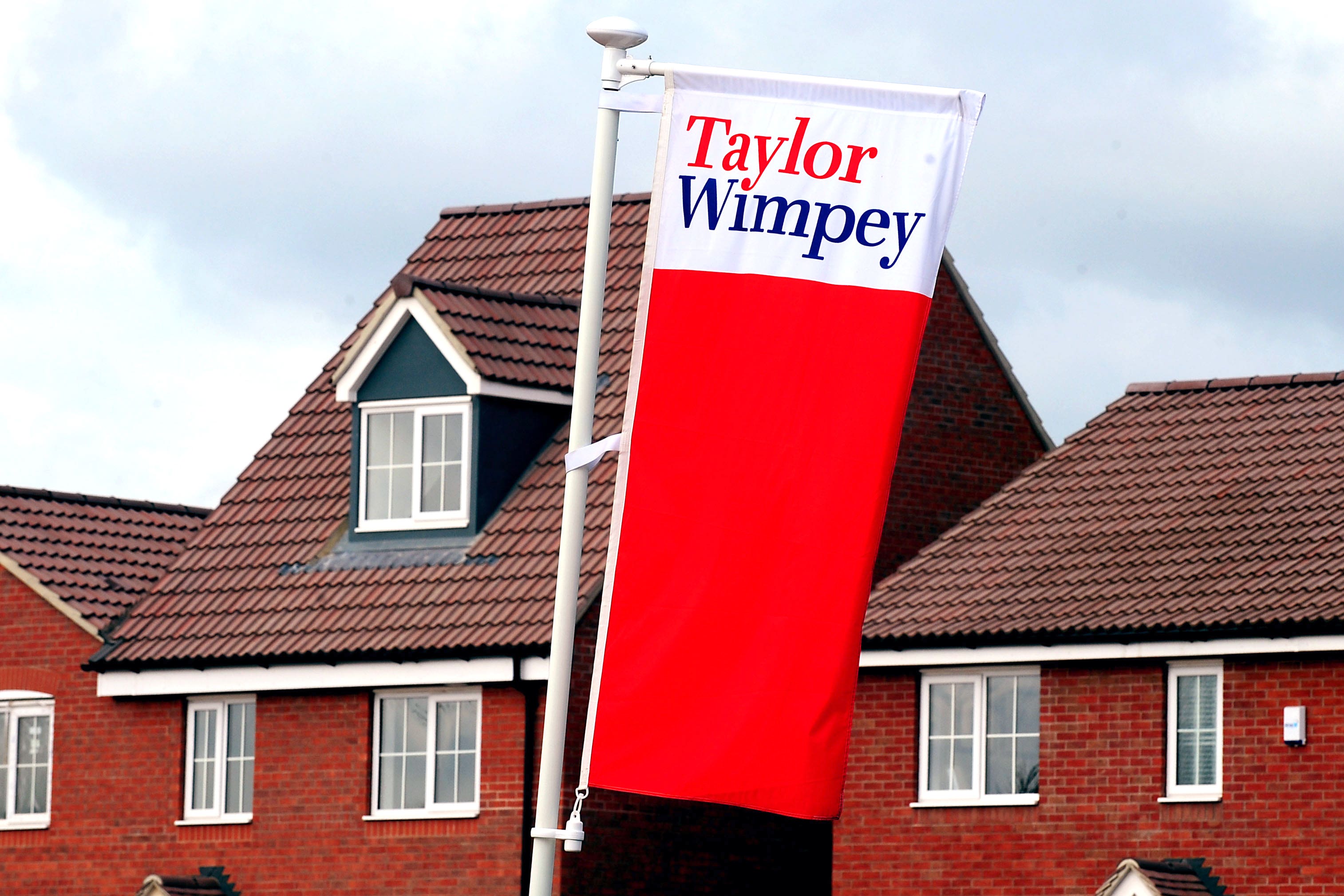 Taylor Wimpey took another £222 million cost hit for removing cladding from high-rise buildings (PA)