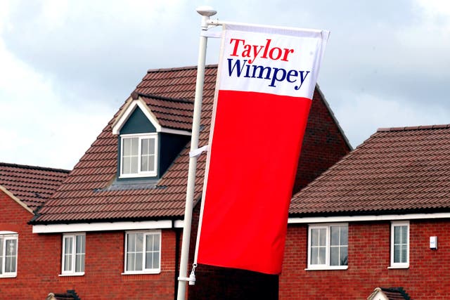 Taylor Wimpey took another £222 million cost hit for removing cladding from high-rise buildings (PA)
