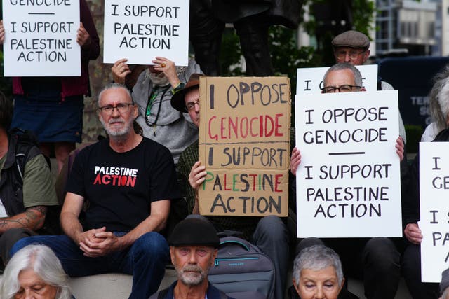 People take part in a protest in support of Palestine Action, organised by the Defend Our Juries group, in front of the Mahatma Gandhi statue in Parliament Square (PA)