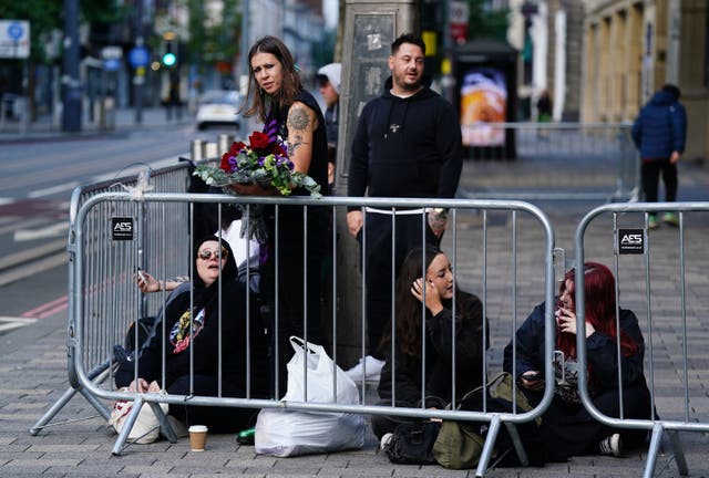 <p>Fans arriving early to get their spot near the Black Sabbath Bridge bench on Broad Street in Birmingham ahead of funeral procession for Black Sabbath frontman Ozzy Osbourne</p>
