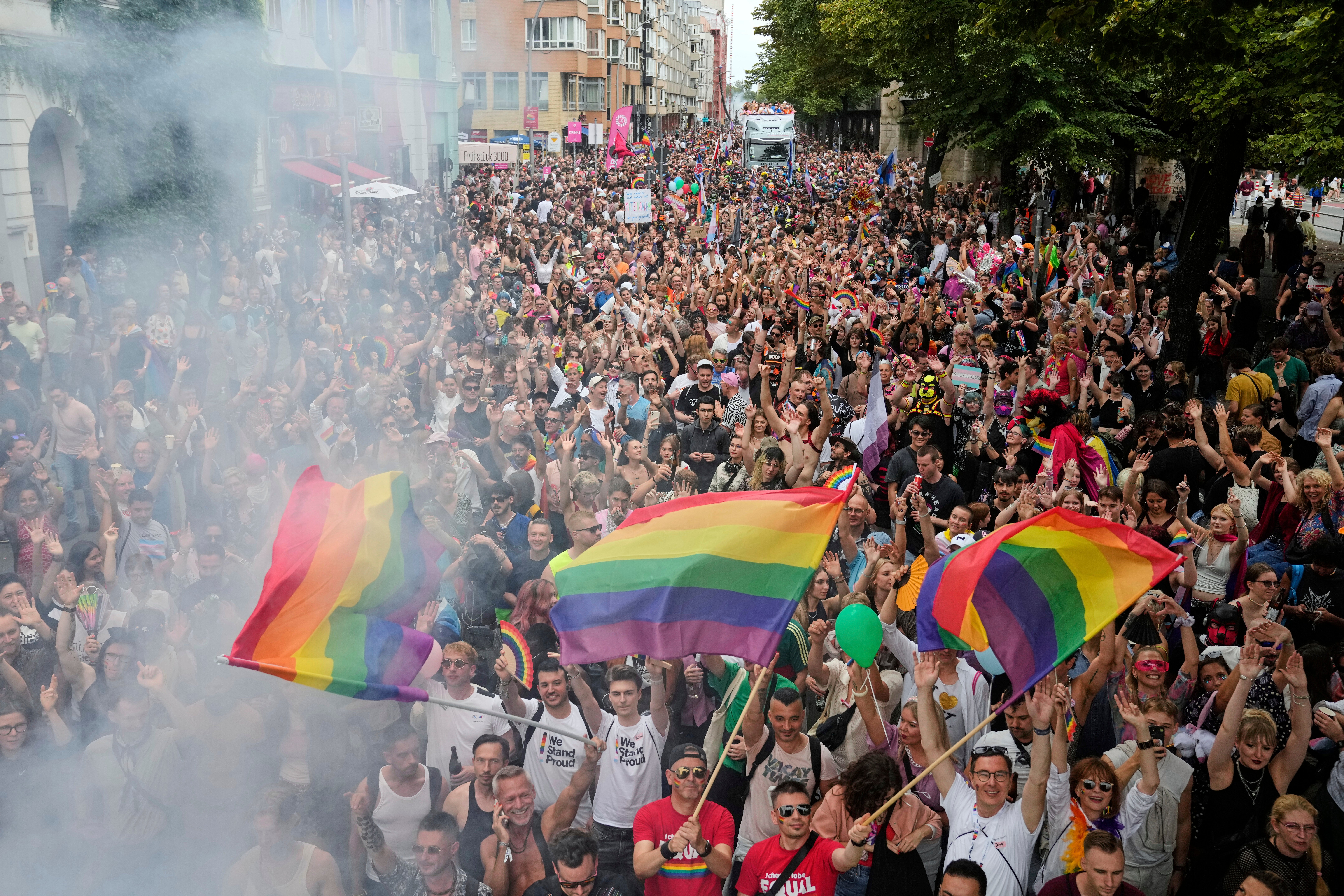 People dance as they take part in the LGBTQ annual pride march in Berlin, Germany, Saturday, July 26, 2025. (AP Photo/Ebrahim Noroozi)