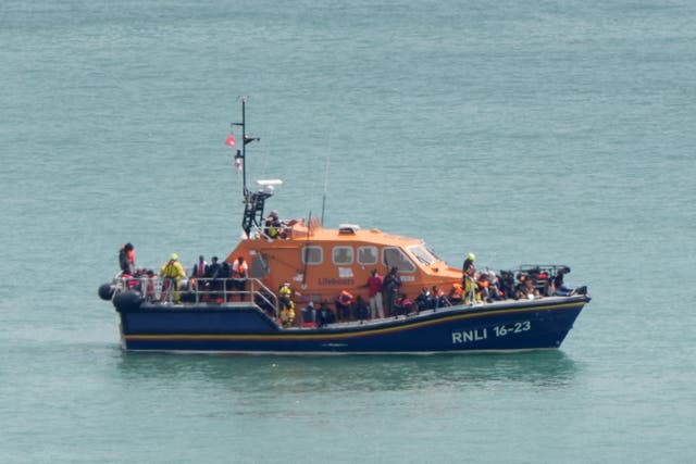 A group of people thought to be migrants are brought in to the Border Force compound in Dover, Kent, from an RNLI Lifeboat following a small boat incident in the Channel (Gareth Fuller/PA)