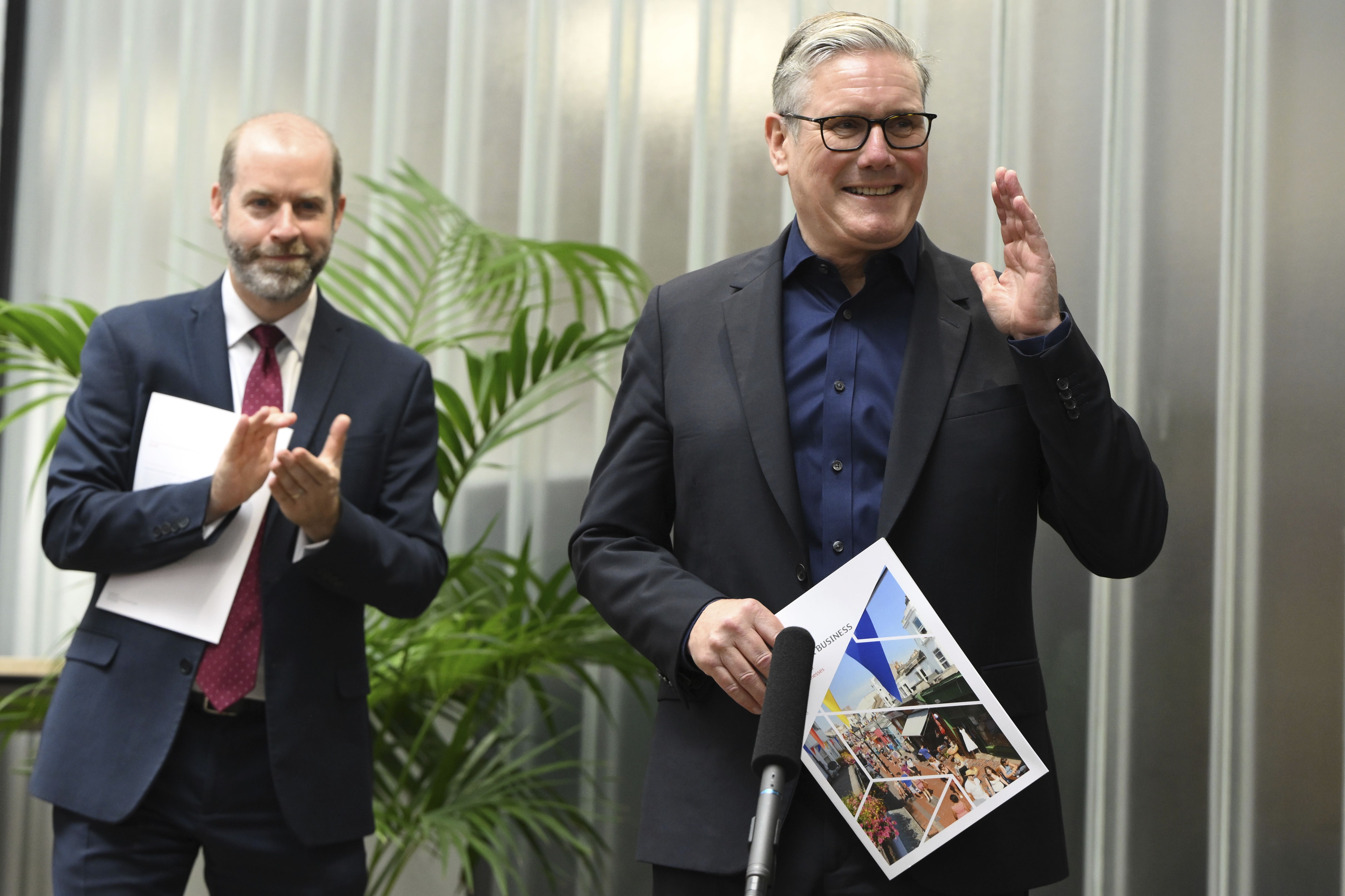 Sir Keir Starmer and Jonathan Reynolds speak to staff members of small businesses at Workshed in Swindon (Anthony Upton/PA)