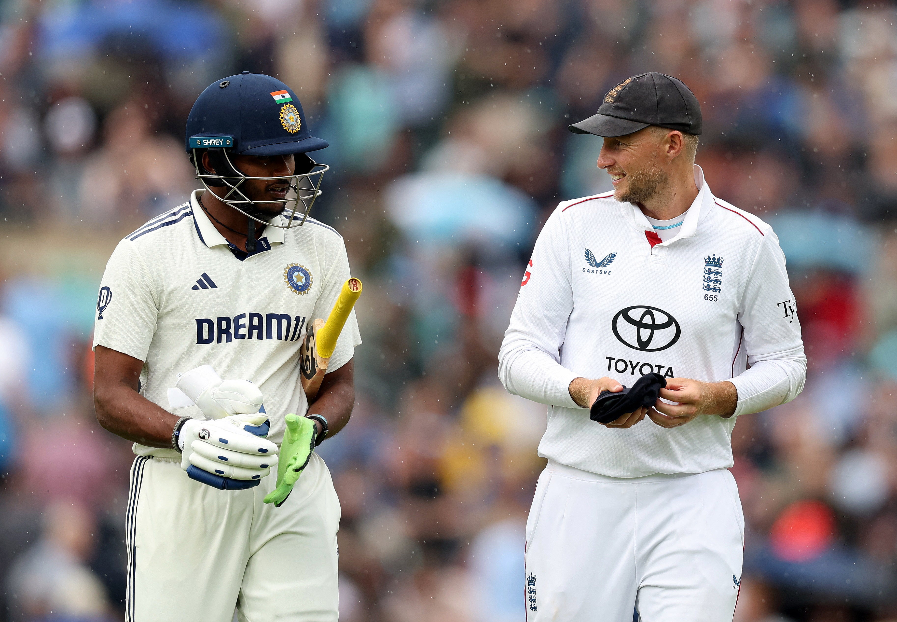 India's Sai Sudharsan speaks to England's Joe Root as rain forces off the players on day one