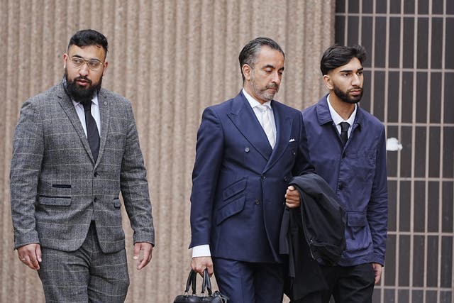 <p>Aamer Anwar (centre) arrives at Liverpool Crown Court with Muhammed Amaad (left) and Mohammed Fahir Amaaz (right) </p>