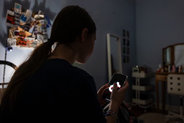 <p>A teenager uses her mobile phone to access social media on January 31, 2024 in New York City</p>