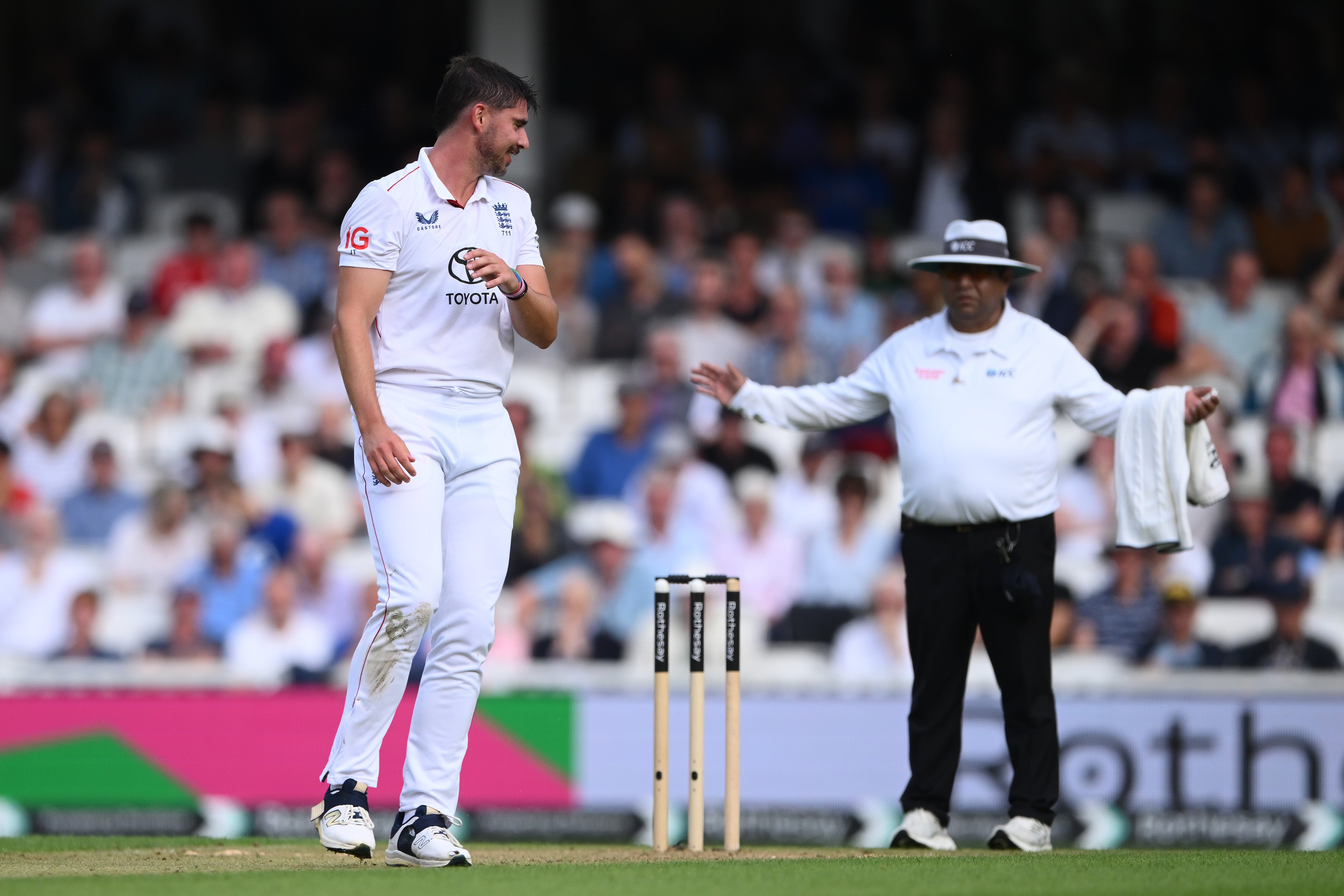 Josh Tongue look on as umpire Ahsan Raza signals another wide
