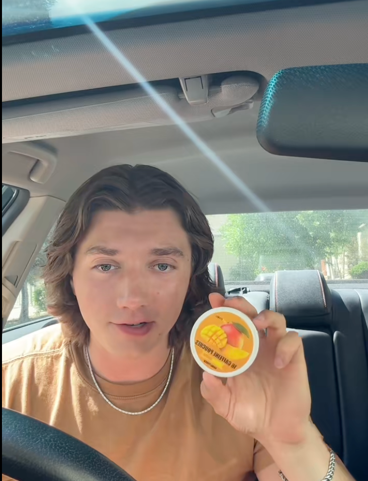 <p>A TikToker explains 13-year-olds can buy and use caffeine pouches while holding a 'Mango Crush' Lyvwel package</p>