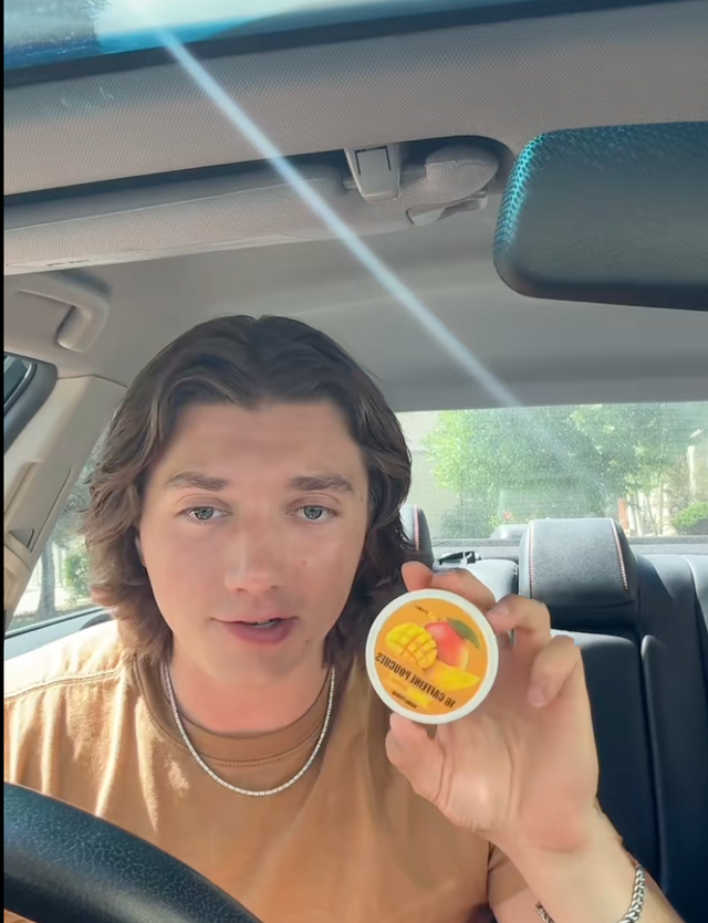 <p>A TikToker explains 13-year-olds can buy and use caffeine pouches while holding a 'Mango Crush' Lyvwel package</p>