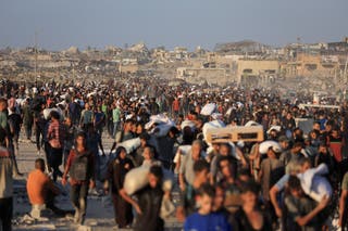 Palestinians carry aid supplies that entered Gaza through Israel, in Beit Lahia