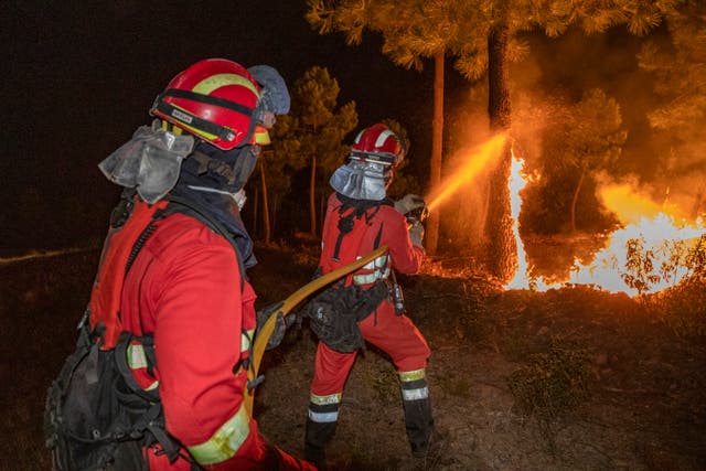<p>This handout photo released by the Military Emergency Unit (UME) on July 31, 2025, shows firefighters battling a wildfire near Caminomorisco, Extremadura region, western Spain. Firefighters battle a wildfire on the ground and in the air in the Spanish province of Avila and in the region of Extremadura. </p>