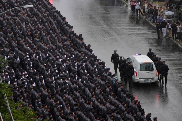 <p>NYPD personnel salute as the hearse carrying the casket of police officer Didarul Islam passes following his funeral</p>
