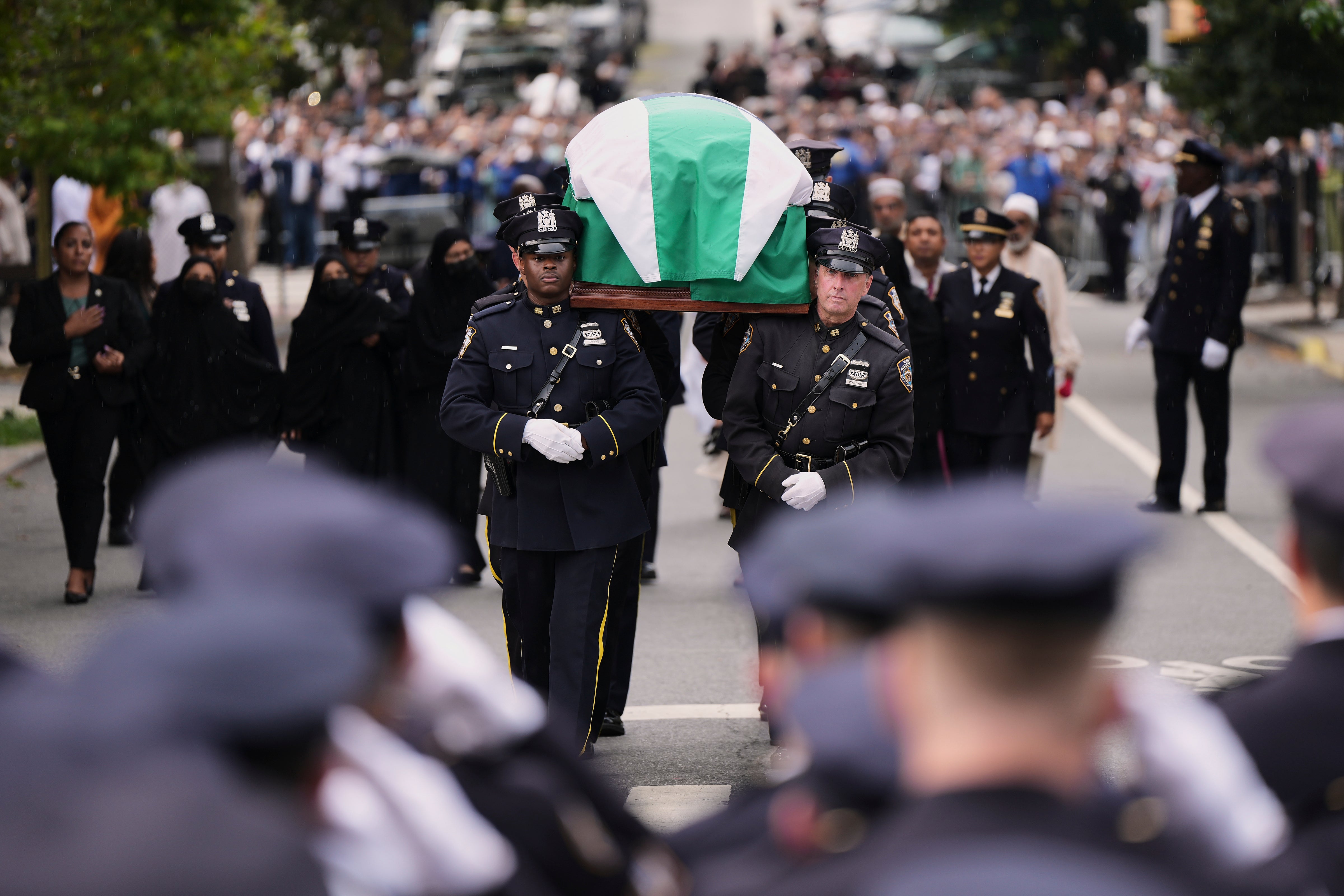 Pallbearers with the NYPD Ceremonial Unit carry the casket of officer Didarul Islam