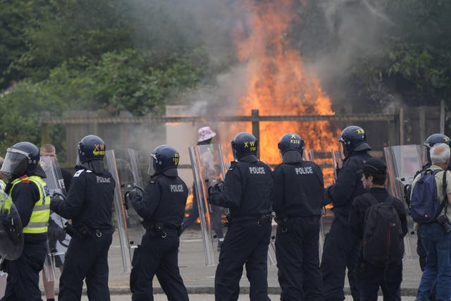 Armed police during a demonstration outside the Holiday Inn Express in Rotherham (Danny Lawson/PA)