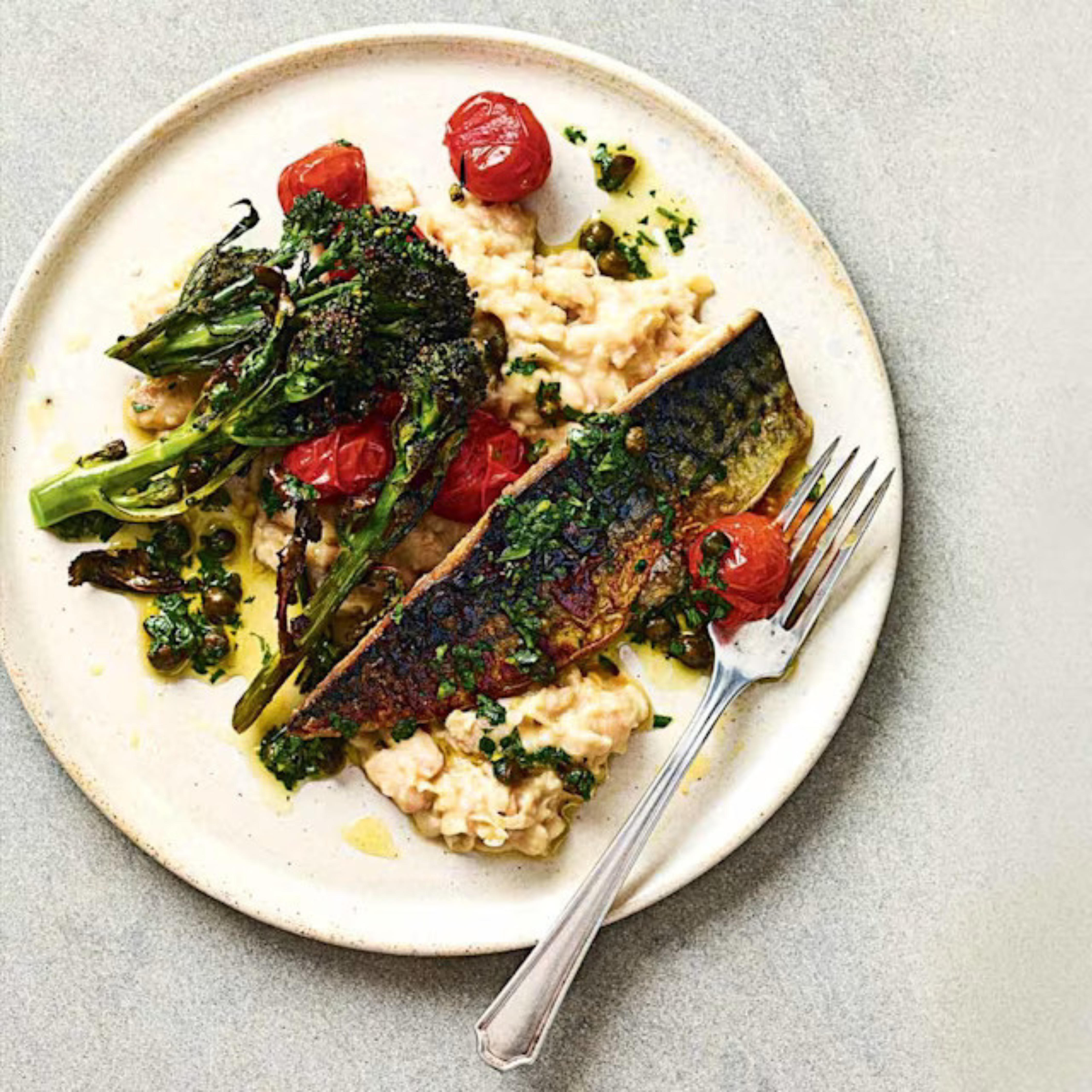 Roasted tomatoes and punchy lemon-caper dressing lift this quick midweek fish supper into dinner-party territory