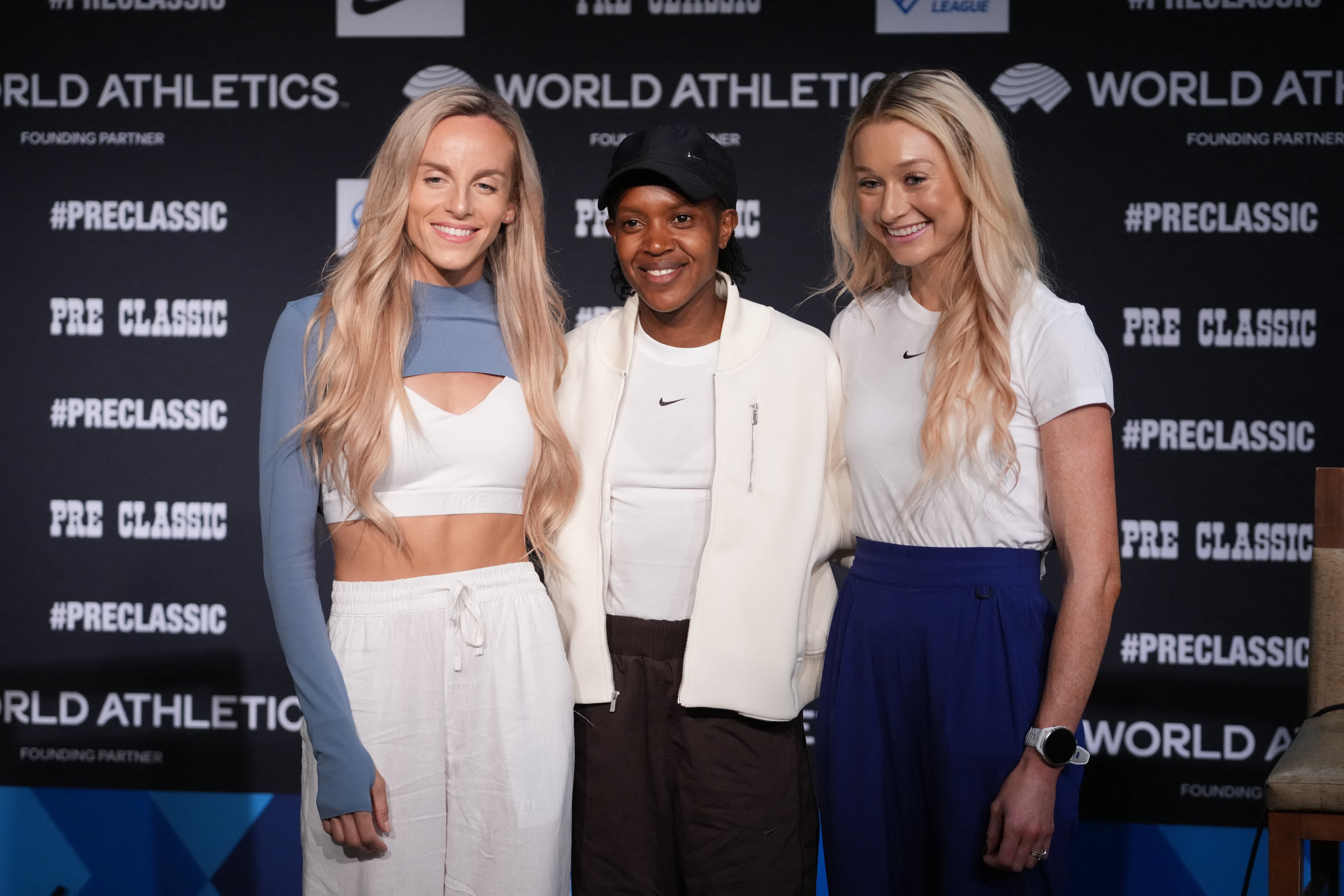 Hunter-Bell poses with fellow Olympic 1,500m medalists Faith Kipyegon and Jessica Hull