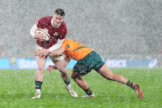 <p>British and Irish Lions' Tommy Freeman (left) is tackled by Australia's Tom Wright during the Qatar Airways Lions Tour match at Accor Stadium</p>