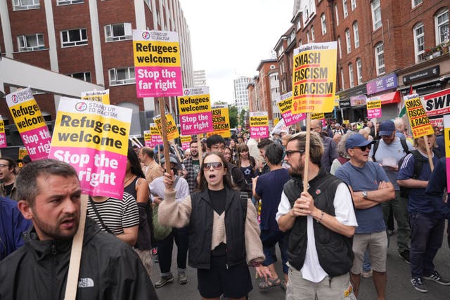 Stand Up To Racism protesters gathered outside the Thistle City Barbican Hotel in central London, which houses asylum seekers (PA)