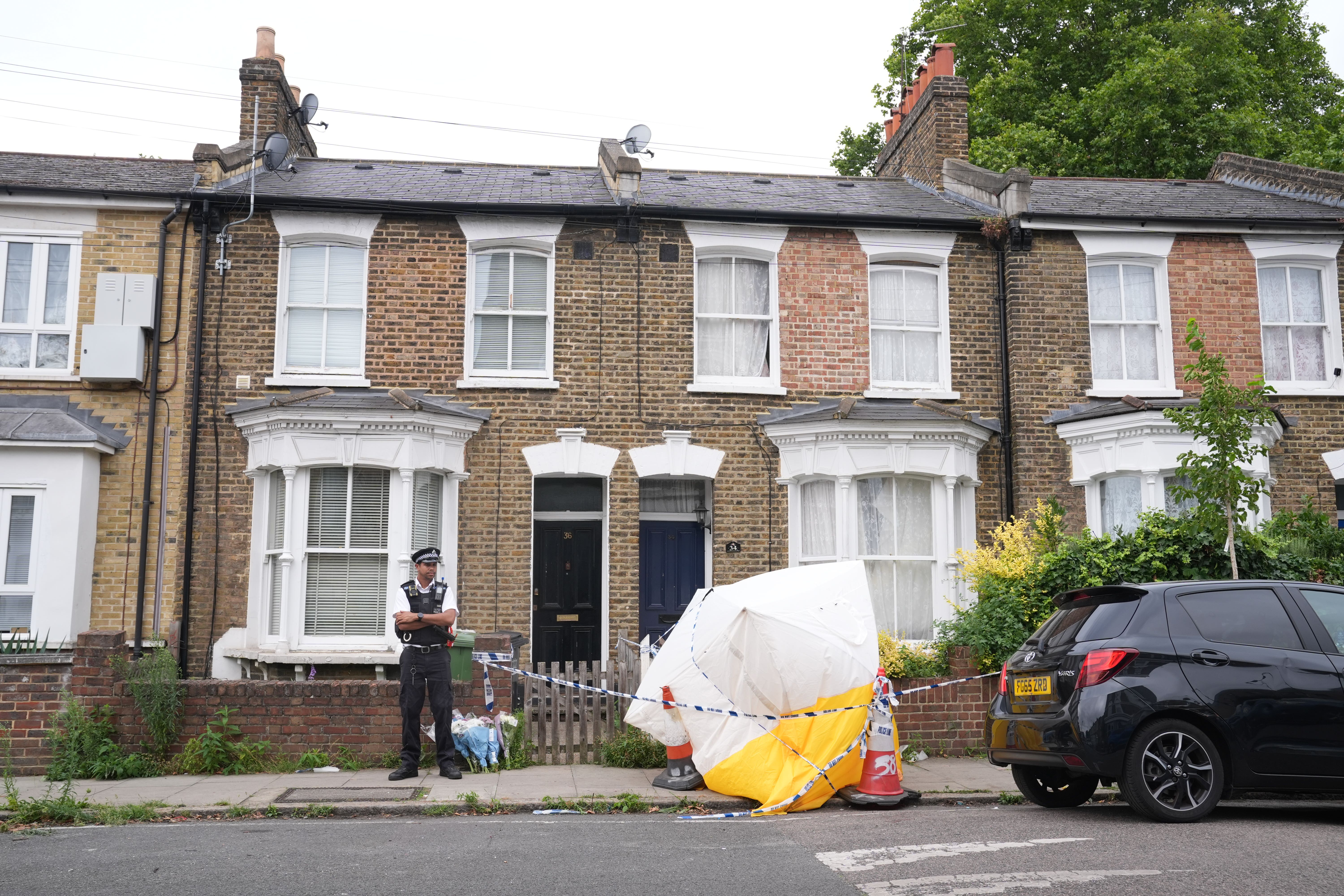 A police officer at the scene in Monson Road, New Cross, south-east London (Lucy North/PA)