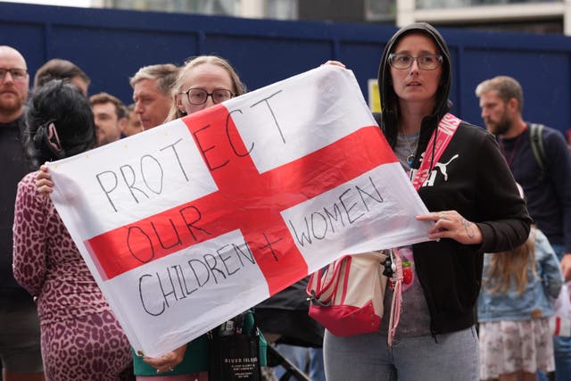 People during a protest near the Britannia International Hotel in Canary Wharf (Lucy North/PA)