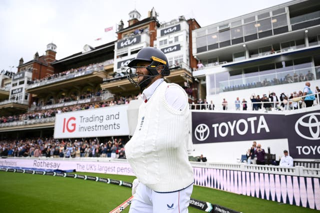 <p>Chris Woakes walked out to play with his left arm in a sling</p>