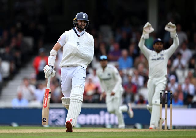 <p>Chris Woakes of England grimaces as he plays with a dislocated shoulder</p>