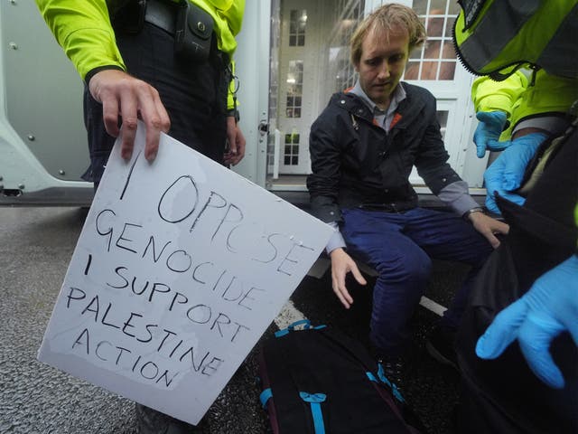 <p>Metropolitan Police officers remove people at a protest in Parliament Square, central London, in support of Palestine Action, organised by Defend Our Juries who are campaigning to de-proscribe the organisation.</p>