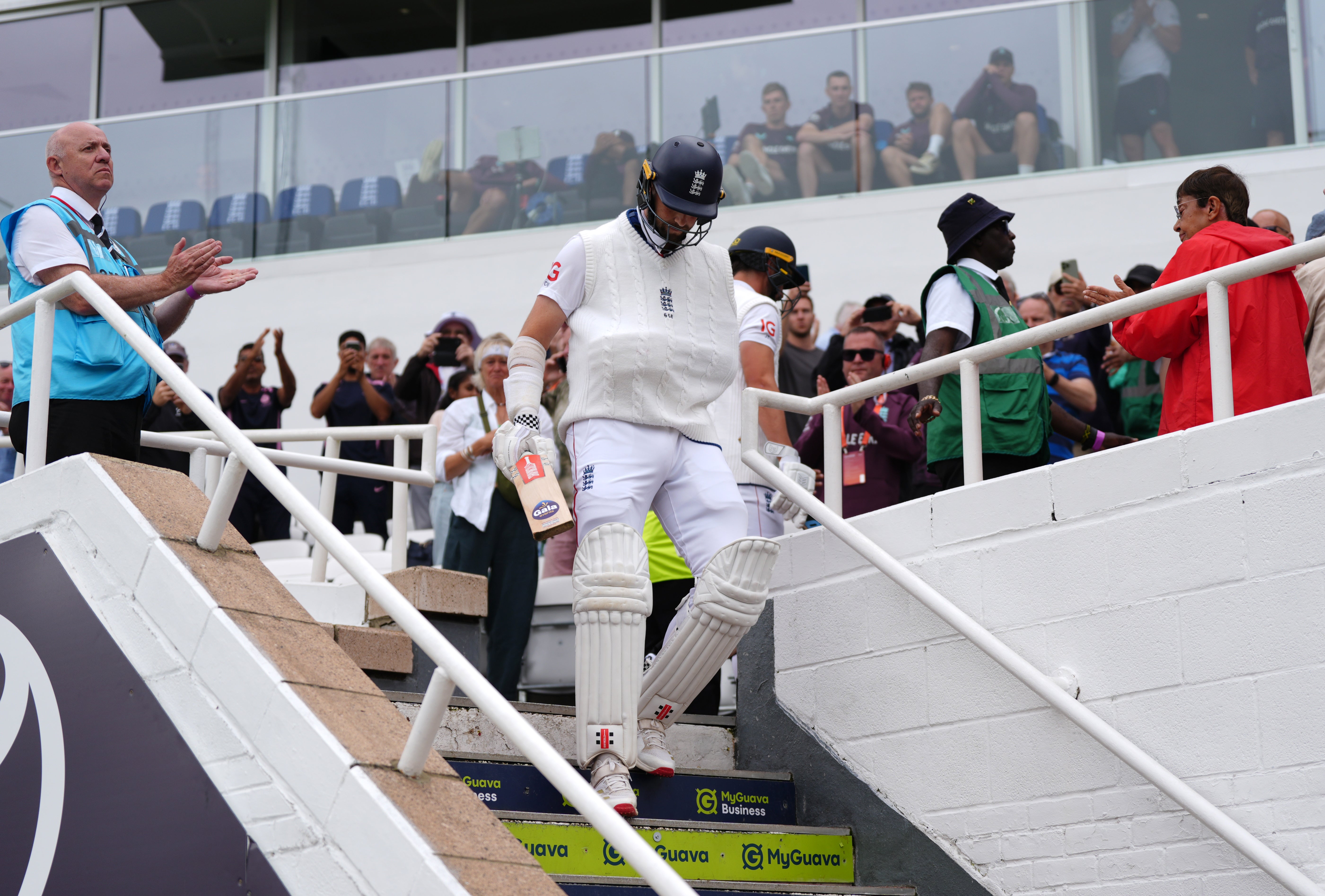 Chris Woakes, with his arm in a sling, heads out to bat (Ben Whitley/PA)